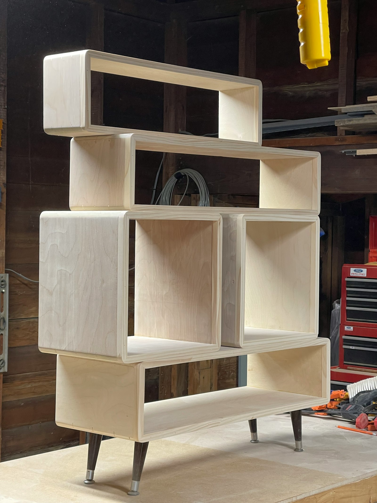 Modular plywood bookcase in a workshop