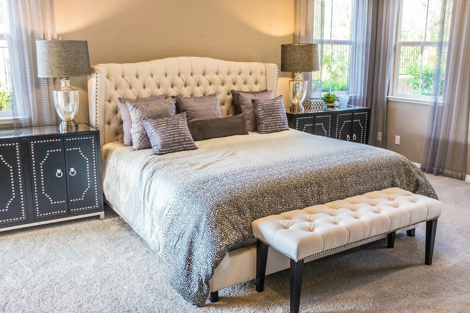 Made bed with white linens in a bright bedroom