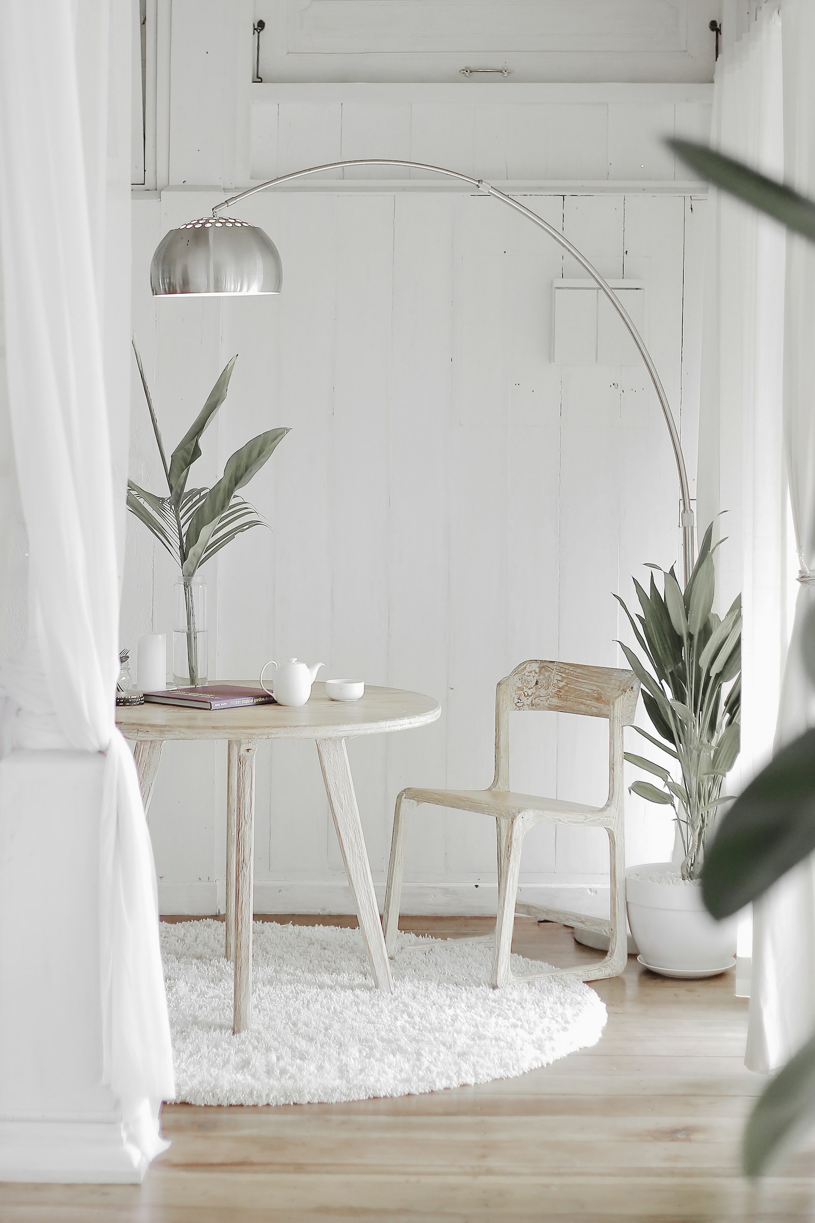White area rug under a round table and chair