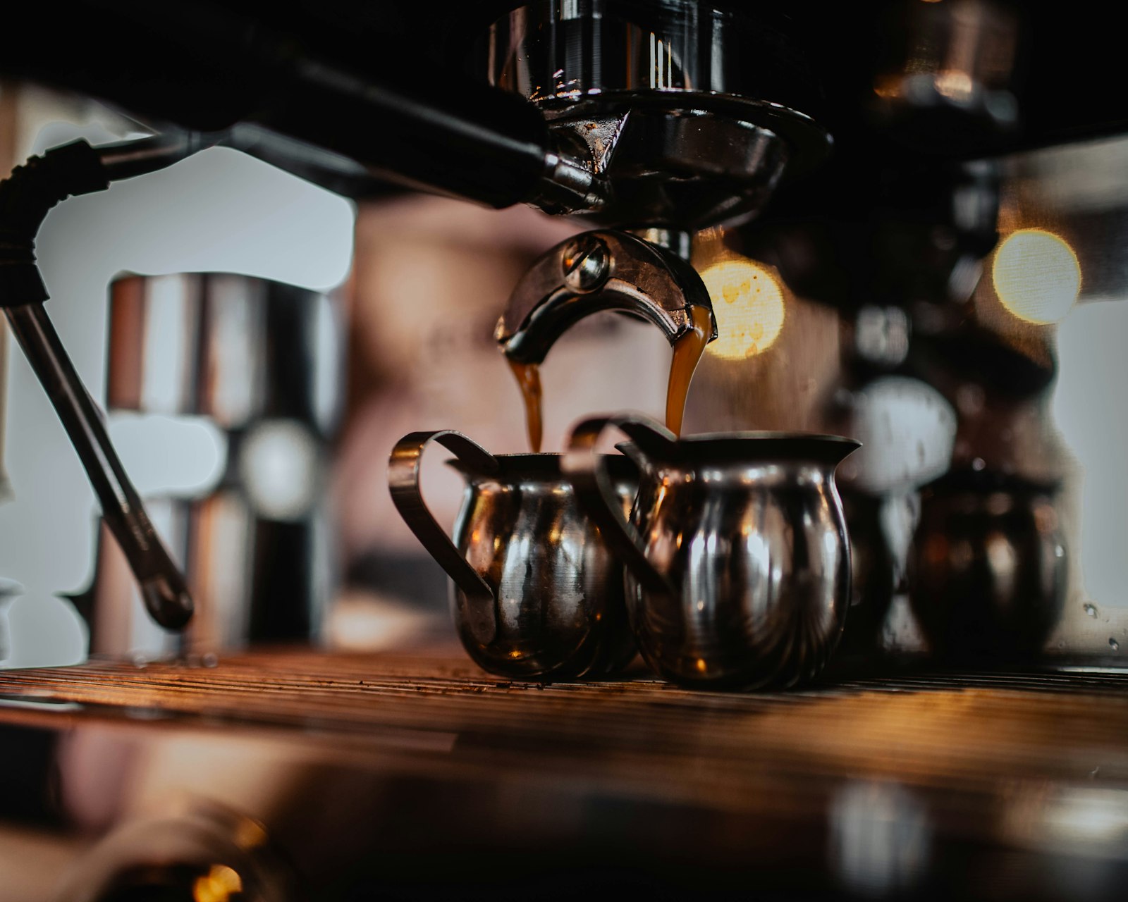 Black coffee maker brewing into a kettle
