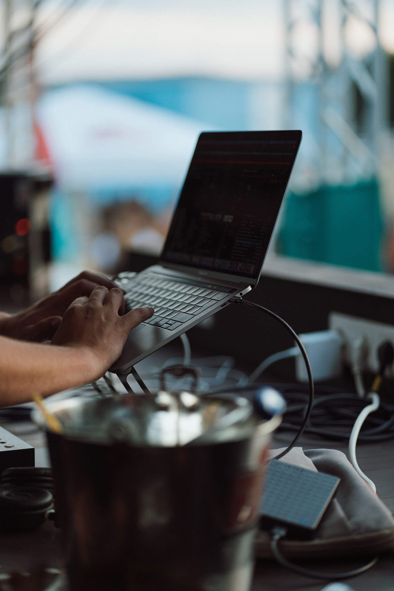 person's hands typing on a laptop